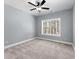This well-lit bedroom offers a spacious layout, large window, and neutral colors perfect for relaxation at 6091 Wayfarer Dr, Villa Rica, GA 30180