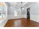 Dining room features hardwood floors, paneled walls, a decorative light fixture, and natural light at 6091 Wayfarer Dr, Villa Rica, GA 30180