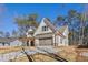Charming two-story home featuring white siding, an attached garage, and ample parking on the concrete driveway at 6091 Wayfarer Dr, Villa Rica, GA 30180