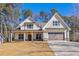 Inviting two-story home with white siding, a covered front porch, and an attached two-car garage at 6091 Wayfarer Dr, Villa Rica, GA 30180
