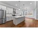 Bright kitchen features stainless appliances, white cabinets, and a large center island at 6091 Wayfarer Dr, Villa Rica, GA 30180