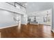 Open living area with hardwood floors, stairs to an upper level, and a modern kitchen at 6091 Wayfarer Dr, Villa Rica, GA 30180