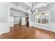 Open living area with hardwood floors, white trim, recessed lights, barn door, and a modern chandelier at 6091 Wayfarer Dr, Villa Rica, GA 30180