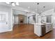 Open-concept living room and kitchen with hardwood floors, a fireplace, and stainless steel appliances at 6091 Wayfarer Dr, Villa Rica, GA 30180