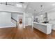 Open-concept living space showcasing hardwood floors and a modern kitchen with island at 6091 Wayfarer Dr, Villa Rica, GA 30180