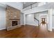 Spacious living room with a brick fireplace, hardwood floors, high ceilings, and a staircase at 6091 Wayfarer Dr, Villa Rica, GA 30180