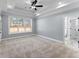 Bright main bedroom features a trey ceiling, ceiling fan, and large window for natural light at 6091 Wayfarer Dr, Villa Rica, GA 30180