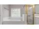 Bathroom with large soaking tub, gold fixtures, and a shower with gold trim at 7415 Marina Cv, Stone Mountain, GA 30087