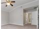 Bedroom featuring neutral walls, carpeting and an open door to the en suite bathroom at 7415 Marina Cv, Stone Mountain, GA 30087