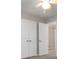 Bedroom featuring neutral walls and carpet, with closet doors and ceiling fan at 7415 Marina Cv, Stone Mountain, GA 30087
