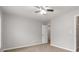 Bedroom with neutral walls and carpet, featuring a ceiling fan and ample natural light at 7415 Marina Cv, Stone Mountain, GA 30087