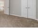 Bedroom featuring neutral walls and carpet, with a closet and doorway at 7415 Marina Cv, Stone Mountain, GA 30087