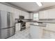Bright kitchen featuring white cabinets, stainless steel appliances, and a center island at 7415 Marina Cv, Stone Mountain, GA 30087
