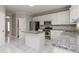 Bright kitchen with white cabinets, stainless steel appliances, and granite countertops at 7415 Marina Cv, Stone Mountain, GA 30087