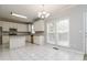 Bright kitchen with white cabinets, stainless steel appliances, and an adjacent dining area by the windows at 7415 Marina Cv, Stone Mountain, GA 30087
