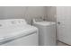 Laundry room featuring a washer, dryer and white door at 7415 Marina Cv, Stone Mountain, GA 30087