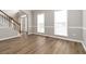 Inviting living room features wood flooring, natural light from the windows, and a staircase at 7415 Marina Cv, Stone Mountain, GA 30087