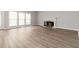 Open living space with wood flooring, fireplace, and large windows providing plenty of natural light at 7415 Marina Cv, Stone Mountain, GA 30087