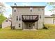 The rear of the home features siding, a large deck, walkout basement, and a big backyard at 7415 Marina Cv, Stone Mountain, GA 30087