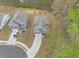 An overhead view showcases a charming blue house nestled among lush trees at 1037 Devon Dr, Acworth, GA 30102