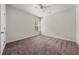 Bright bedroom with neutral carpet, window view, ceiling fan, and crisp white trim at 1037 Devon Dr, Acworth, GA 30102