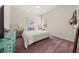 Bright bedroom featuring a patterned accent wall, soft lighting, and plush carpet at 1037 Devon Dr, Acworth, GA 30102