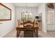Bright dining room with wooden table and chairs illuminated by natural light from the window at 1037 Devon Dr, Acworth, GA 30102