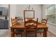 Cozy dining room with wood table, chairs, chandelier, and a window that brings in natural light at 1037 Devon Dr, Acworth, GA 30102