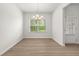 An empty dining room featuring a window view, modern art, and hardwood flooring at 1037 Devon Dr, Acworth, GA 30102