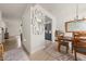 A bright dining room with wood floors, a decorative mirror, and a charming table setting at 1037 Devon Dr, Acworth, GA 30102