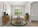 Dining room with circular table, four chairs, window view and modern art at 1037 Devon Dr, Acworth, GA 30102