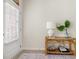 The entryway features a bamboo console table, decor, and a door with window and blinds at 1037 Devon Dr, Acworth, GA 30102