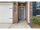 Close-up of the front entrance, showing the brick facade and blue door with house number at 1037 Devon Dr, Acworth, GA 30102