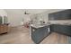 Open-concept kitchen with island, grey cabinets, granite countertops, and stainless steel appliances overlooking the living room at 1037 Devon Dr, Acworth, GA 30102
