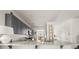 Open-concept kitchen with granite countertops, gray cabinets, stainless steel appliances at 1037 Devon Dr, Acworth, GA 30102