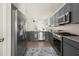 Spacious kitchen featuring gray cabinets, stainless steel appliances, and ample counter space for cooking and entertaining at 1037 Devon Dr, Acworth, GA 30102
