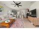 Open-concept living space featuring hardwood floors, a comfortable sofa, and seamless flow to the modern kitchen at 1037 Devon Dr, Acworth, GA 30102