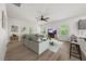 A bright living room with hardwood floors, neutral sectional sofa, and a ceiling fan at 1037 Devon Dr, Acworth, GA 30102