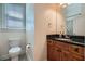 Stylish half bathroom features granite counters and wooden cabinets at 1714 Parkhill Dr, Decatur, GA 30032