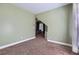 View of a bedroom with green walls, carpet flooring, and natural light coming through the window at 1714 Parkhill Dr, Decatur, GA 30032