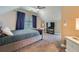 Comfortable bedroom features plush carpet, a ceiling fan, a TV, and a luxurious upholstered bed at 1714 Parkhill Dr, Decatur, GA 30032