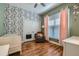Charming Bedroom with playful wallpaper, soft lighting, and a cozy rocking chair at 1714 Parkhill Dr, Decatur, GA 30032
