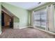 Bright bedroom with green walls, carpet flooring, and a window with natural light at 1714 Parkhill Dr, Decatur, GA 30032
