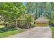 Charming home featuring a well-maintained lawn, complemented by an attached two-car garage and lush trees at 1714 Parkhill Dr, Decatur, GA 30032