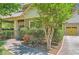Beautiful home with landscaped yard, sidewalk leading to the front door, and a garage on the side at 1714 Parkhill Dr, Decatur, GA 30032