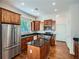 Modern kitchen featuring wooden cabinets, granite countertops, stainless steel appliances, and a center island at 1714 Parkhill Dr, Decatur, GA 30032