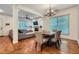 Open living space with dining area, hardwood floors, gray sofa, fireplace, and access to the kitchen at 1714 Parkhill Dr, Decatur, GA 30032