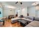 Open living space with hardwood floors, an ample gray sofa, and a dining area featuring a modern chandelier at 1714 Parkhill Dr, Decatur, GA 30032