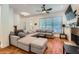 Spacious living room features hardwood floors, gray sectional couch, and a stone fireplace with mounted TV at 1714 Parkhill Dr, Decatur, GA 30032