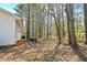 Side yard view with a home's exterior and a glimpse of the surrounding trees and natural setting at 5955 Kemp Dr, Acworth, GA 30102